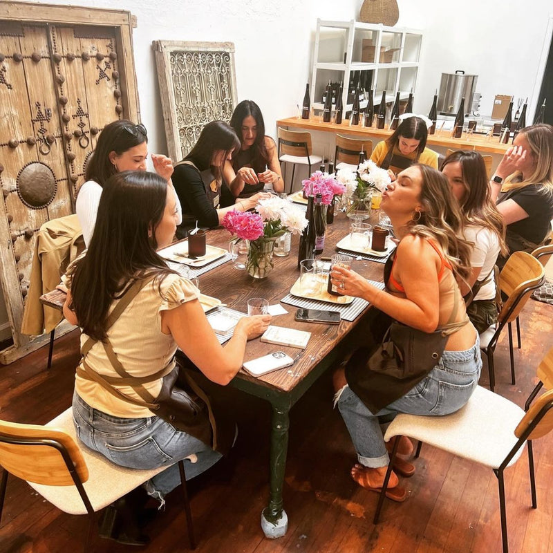 A group of women pouring candles together at a girls' day candle class in Petaluma