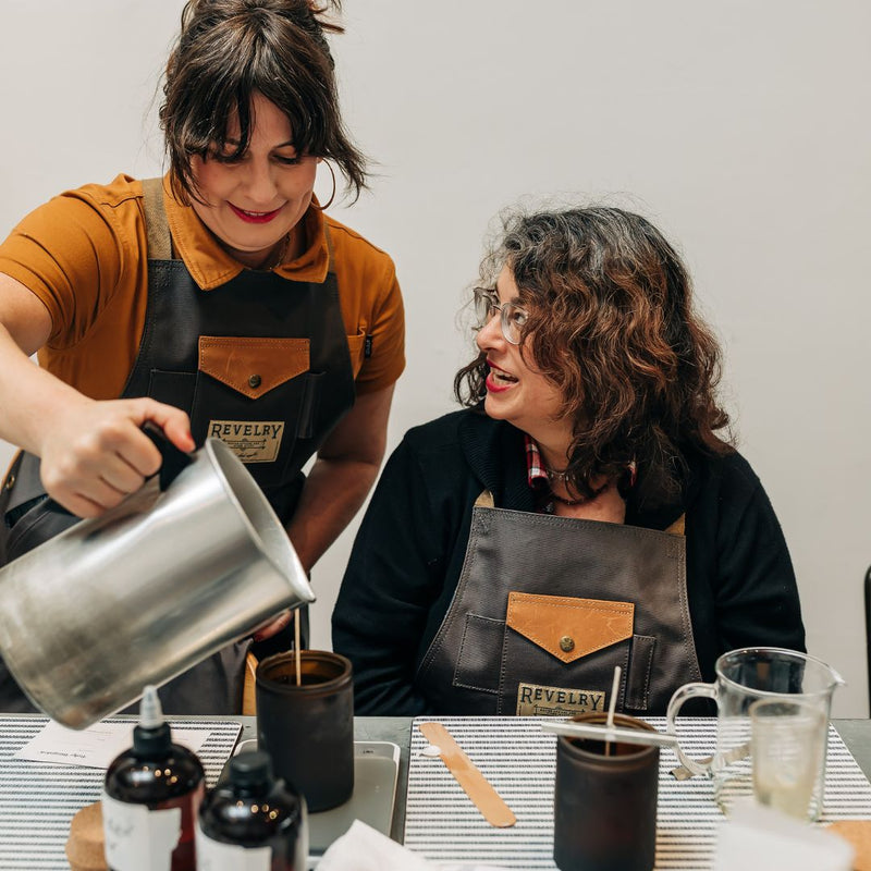 An instructor guiding a single student through pouring a candle at Boho Bungalow in Petaluma